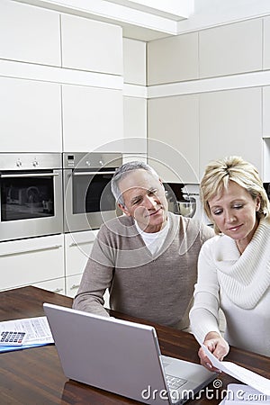 Couple Calculating Home Finances On Laptop Stock Photo