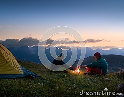 Couple camping at night Stock Photo