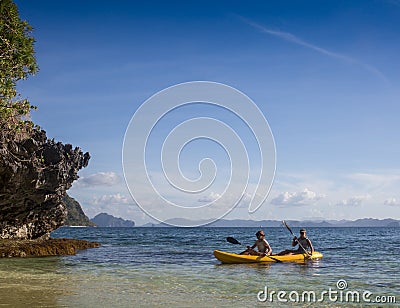 Couple canoeing in lagoon of West French indies Stock Photo