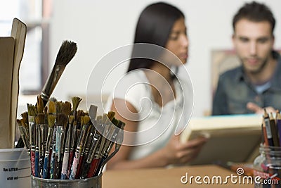 Couple With Canvases In Artist Studio Stock Photo