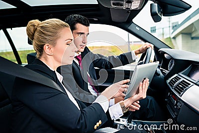 Couple in car being lost navigating with map Stock Photo