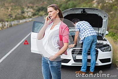 Couple after a car breakdown Stock Photo