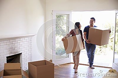 Couple Carrying Boxes Into New Home On Moving Day Stock Photo