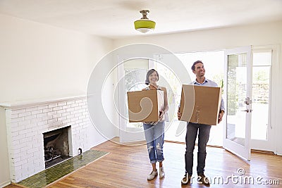Couple Carrying Boxes Into New Home On Moving Day Stock Photo