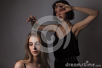 Couple of Caucasian Lesbian Girls Playing Together With Bright Makeup Over Black Background Stock Photo