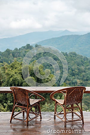 Couple chairs on balcony of countryside home or homestay with mountain view background in the morning Stock Photo