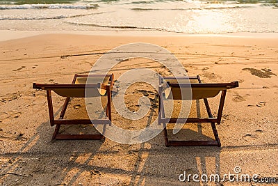 A couple of chairs on sunset beach Stock Photo