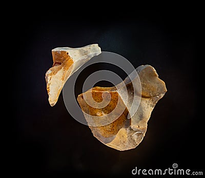 A couple of chalcedony mineral nuggets from Novy Volkovysk, Belarus. A photo of stones isolated on black. For Geology minerology Editorial Stock Photo