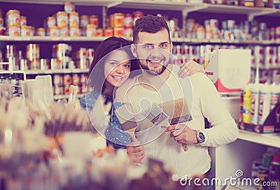 Couple choosing brush for house decoration Stock Photo