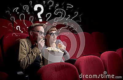 Couple in cinema with questions Stock Photo