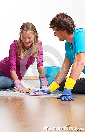 Couple cleaning the floor Stock Photo