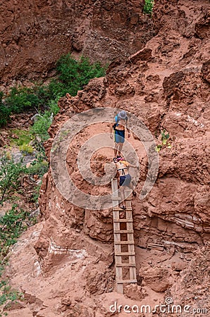 Couple Climbing Ladder - Havasupai Waterfalls - Arizona Editorial Stock Photo