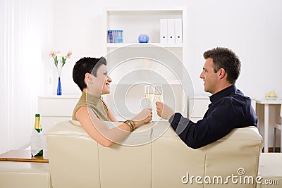 Couple clinking champagne Stock Photo