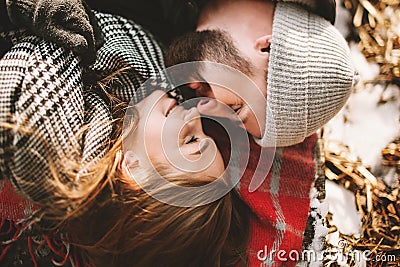 Couple close lying on plaid in winter park Stock Photo