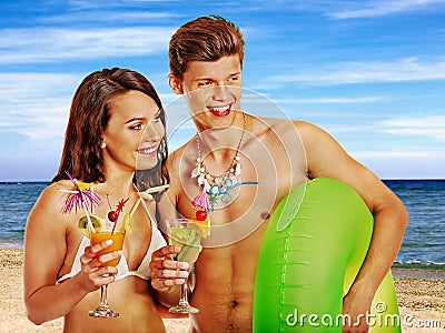 Couple with cocktail at Hawaii wreath beach. Stock Photo