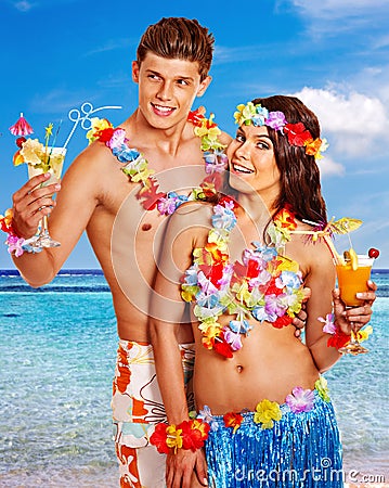 Couple with cocktail at Hawaii wreath beach. Stock Photo