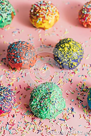 Couple of colorful sprinkled donuts on a pink background Stock Photo