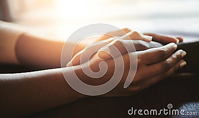 Couple comforting, supporting and holding hands on a table. An African man and woman showing love, compassion and Stock Photo