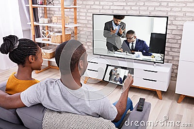 Couple Connecting Television Through Wireless On Tablet Stock Photo