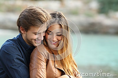 Couple cuddling affectionate on the beach Stock Photo