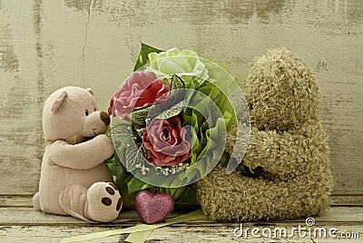 Couple of cute bears holding roses bouquet Stock Photo