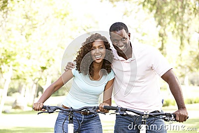 Couple On Cycle Ride in Park Stock Photo