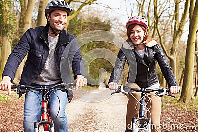 Couple On Cycle Ride In Winter Countryside Stock Photo