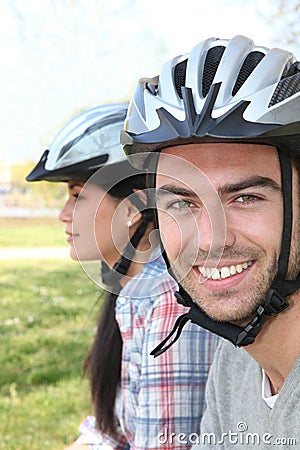 Couple of cyclists wearing helmets Stock Photo