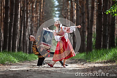 Couple dancing in russian traditional dress on nature Stock Photo