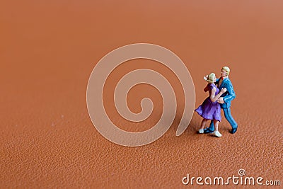 Couple dancing on a smooth brown background Stock Photo