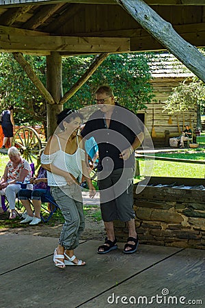 Couple Dancing to Mountain Music Editorial Stock Photo