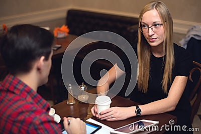 Couple is on date in cafe drinking coffee, girl Stock Photo