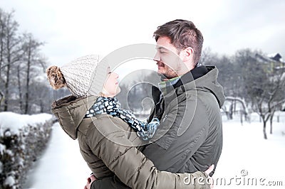 Couple dating and hugging in winter park Stock Photo