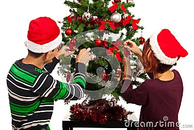 Couple decorate Christmas tree Stock Photo