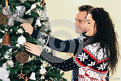 Couple decorating christmas tree Stock Photo