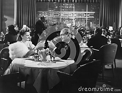 Couple dining in crowded restaurant Stock Photo