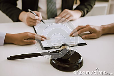 Couple is divorced who handed their engagement ring to the divorce documents that the lawyer was clarifying Stock Photo