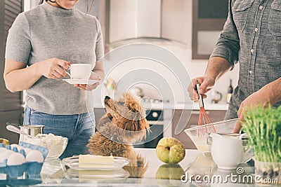 Couple with dog is making breakfast . Stock Photo