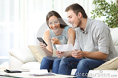 Couple doing accounting with a phone bank app Stock Photo