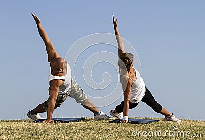 Couple doing yoga in nature Stock Photo