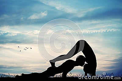 Couple doing yoga pose Stock Photo