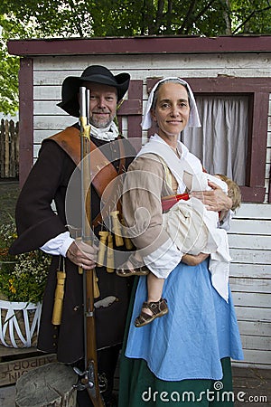 Couple dressed up as a 17th century soldier and his King`s Daughter wife and baby during the New France Festival Editorial Stock Photo