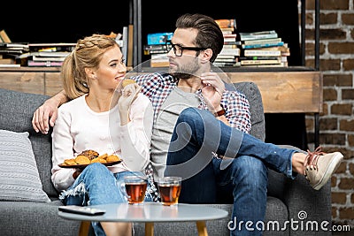 Couple drinking tea with biscuits Stock Photo