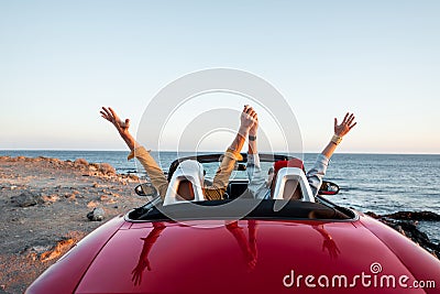 Couple driving convertible car near the ocean Stock Photo