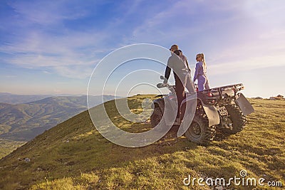Couple driving off-road with quad bike or ATV Stock Photo