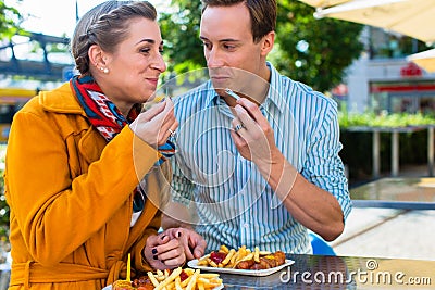 Couple eating German Currywurst Stock Photo