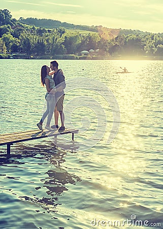 Couple embrace on the pier Stock Photo