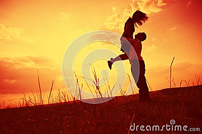 Couple embracing at sunset Stock Photo