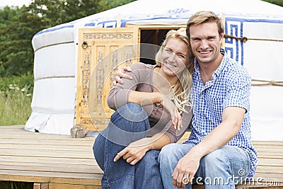 Couple Enjoying Camping Holiday In Traditional Yurt Stock Photo