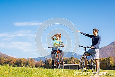 Couple enjoying cycling in the countryside during fall weekend trip Stock Photo